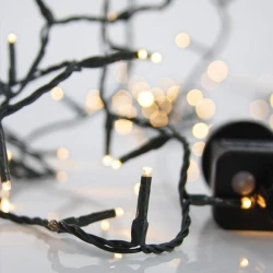 180 LED λαμπάκια σε σειρά με θερμό λευκό φως 8 προγράμματα, πράσινο PVC καλώδιο και 31V μετασχηματιστή, ανά 5cm, παροχή 3m IP44